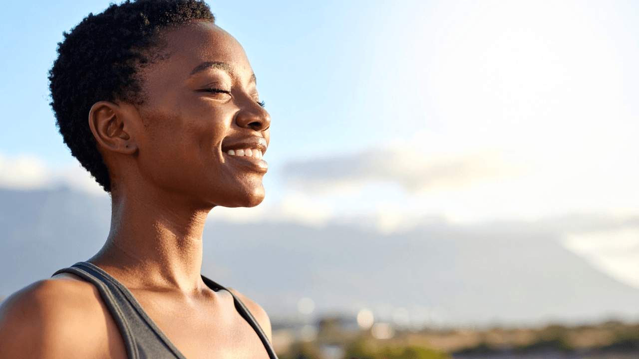 A woman outdoors at golden hour.
